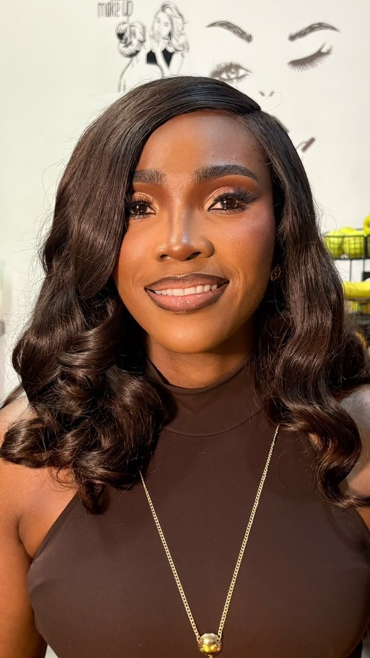 Dark wavy curled wig installation with soft glam makeup